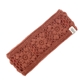 A handmade flower crochet headband in rust with fleece lining.