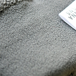 A close-up of the Gateway Hat shows gray fabric with a small circular stain in the center and a partially visible white tag at the top right.