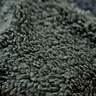 Close-up view of the Anna Hood’s dark green fleece fabric, featuring a soft, plush texture with visible fibers.