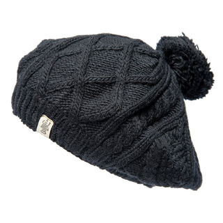 A handmade in Nepal Yves Beret with a pom pom.