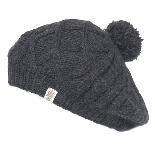 A black merino wool Yves Beret with a pom pom.