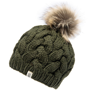 The Boheme Cable Beanie w/ Faux Fur Pom is a green knitted winter beanie featuring a chunky braided pattern and topped with a fluffy brown faux fur pom-pom. Made from 100% Merino wool, it includes a small label with a logo on the front edge.