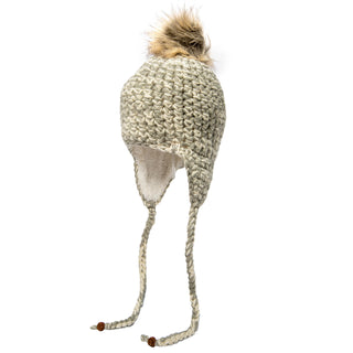 The Chunky Knit Earflap Hat boasts braided ties and a faux fur pom-pom, crafted in beige with cozy Sherpa fleece lining on the earflaps to provide warmth and style during chilly days.