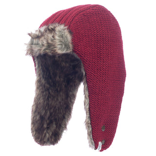 The Winter Trapper Hat features a red knit design with a textured exterior. Its interior and ear flaps are lined with plush, brown faux fur, which can be fastened securely with buttons.