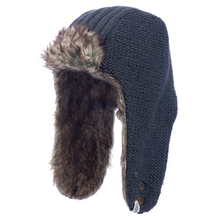 The Winter Trapper Hat is a dark wool cap with a faux fur-lined interior and extended ear flaps, one of which features two visible buttons.
