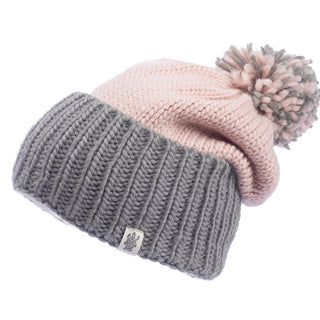 The Masha Pom Slouch is a handmade knitted beanie featuring a gray ribbed band, a light pink top, and a pom-pom in shades of pink and gray on the top.
