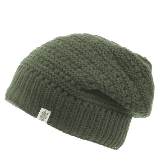A green Boho Slouch knitted winter hat with a woven texture and a small white label featuring a logo. This wool hat boasts a relaxed, boho slouch fit.