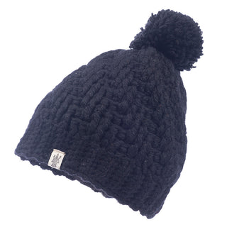 A black merino wool swirl pom beanie.