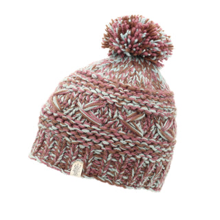 The Reverse Cross Pom Pom Hat is a knitted beanie featuring a mix of pink, brown, white, and light blue yarns. It has a chunky textured pattern and sports a pom-pom on top along with a small tag decorated with an emblem.