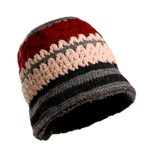 The Stripe Sun Hat is a hand-knit beanie from Nepal, showcasing horizontal stripes in red, beige, gray, and dark gray. Its design alternates between solid sections and textured, lighter-colored stitches. Crafted from soft merino wool, this hat features a rounded top and a subtly flared bottom edge.