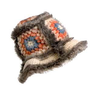 The Crochet Sun Hat With Fur Piping is a hand-crocheted piece featuring a granny square design with multicolored yarn in shades of blue, orange, and cream. Ideal for cold-weather fashion, it is finished with fluffy gray faux fur piping along the edges.
