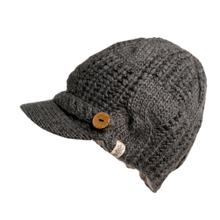 Introducing the Broadway Hat, a dark gray, cable knit hat with a textured pattern. It features a short brim and a decorative button on the left side. Made from thick yarn, this hat is an essential addition to your winter wardrobe.