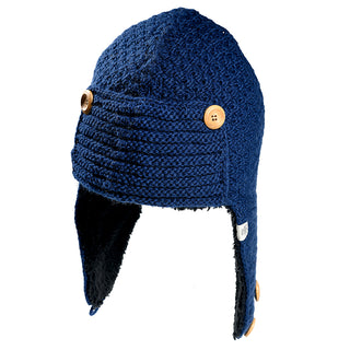 The Elk Hat is a blue knit winter hat featuring ear flaps, three wooden button accents, and a visible black fleece lining inside the ear flaps.