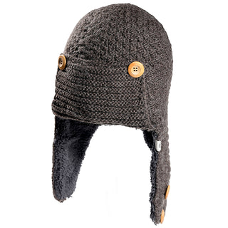 The Elk Hat is a brown knit winter hat with ear flaps, lined with dark fleece, and features three visible brown buttons—two on the sides and one near the bottom of an ear flap.