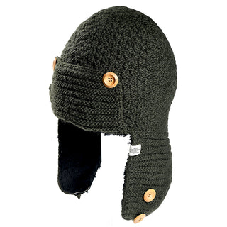 The Elk Hat is a dark knitted winter hat with ear flaps, featuring four light brown buttons, a soft black lining, and a small fabric label sewn on one flap.