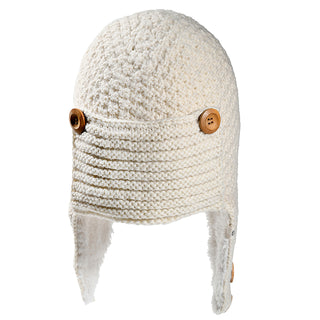 The Elk Hat is a white knitted hat with ear flaps, showcasing a textured, soft look and a horizontal ribbed front panel fastened by two large brown buttons on each side.