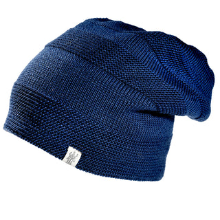 The Edgar Slouch is a dark blue knit beanie with a ribbed texture and a small white rectangular tag on the folded brim, shown against a white background.