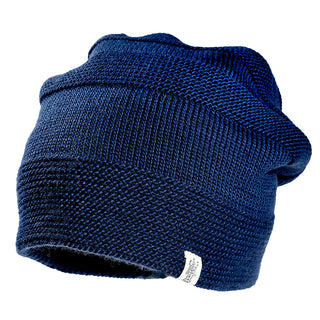 The Edgar Slouch is a dark blue knitted beanie with a slouchy fit and a small white fabric tag on the brim, shown against a plain white background.