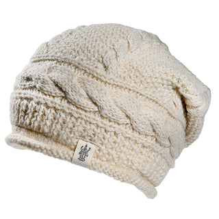 The Gateway Hat is a cream-colored knitted beanie featuring a thick cable-knit pattern and a small logo fabric tag on the brim, displayed on a white background.