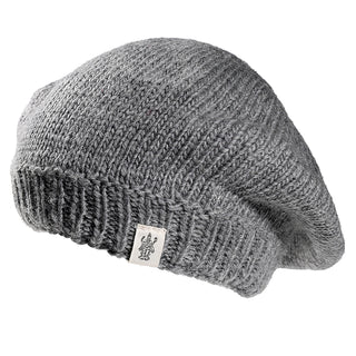 The Abbey Hat is a gray knitted beret with a ribbed edge and a small white logo tag, shown against a white background.