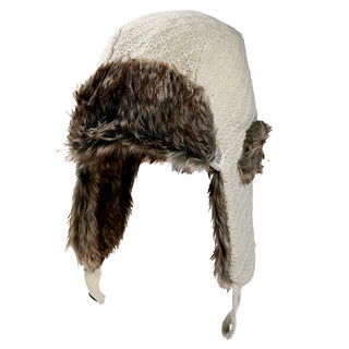 The Fern Hat is a white trapper hat featuring a textured knit exterior and brown faux fur lining on the ear flaps, front, and inside. Its ear flaps can hang down or be tied under the chin.