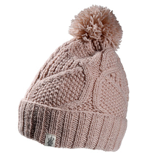 The Cedar Hat is a light pink knitted beanie featuring a ribbed fold-over cuff, textured pattern, large pom-pom on top, and a small white logo tag on the brim.