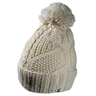 The Cedar Hat is a cream-colored beanie with a textured cable knit, a large yarn pom-pom on top, and a folded brim.
