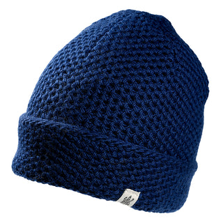 The Baltic Hat is a navy blue knitted beanie featuring a folded brim and a small white tag, shown against a white background.