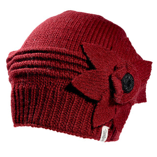 The Monroe Hat is a maroon knitted beanie featuring a layered ribbed design and a large matching felt flower with a black button center attached to the side.