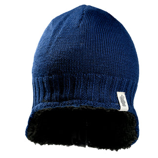 The Dakota Hat, a blue knit winter hat featuring a ribbed edge, black furry lining, and a small white side tag, is displayed against a white background.