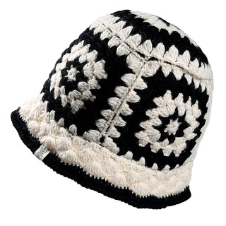 The Milie Hat is a crocheted bucket hat with black and white geometric granny squares, featuring alternating concentric circles and a slightly flared brim.
