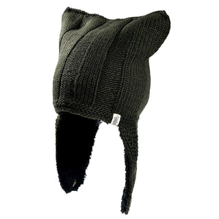 The Ezra Hat is a dark knitted hat featuring two pointed, ear-like shapes on top, long ear flaps down each side, and a small white tag attached to the front ear flap.