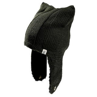 The Ezra Hat is a dark knit hat with pointed ear-like shapes on top, long ear flaps, and a small fabric tag on the side.