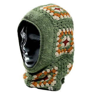 A black mannequin head displays the Ryan Hood, a green crochet balaclava with granny square patterns in green, beige, white, and brown. The balaclava covers the head and neck, leaving only the face visible.