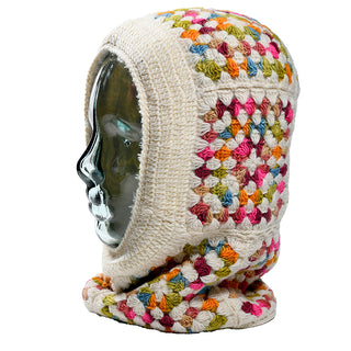 A glass mannequin head showcases the Ryan Hood, a crocheted balaclava featuring colorful granny squares in cream, orange, green, pink, blue, and yellow against a plain white background.