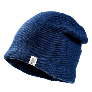 The Depp Slouch is a dark blue slouchy beanie with a small white tag featuring a design, shown against a white background. A cozy wool hat ideal for winter.