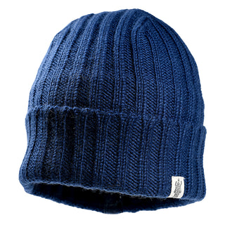 The Clyde Rib Fold Cap is a blue ribbed knit beanie with a folded brim and a small white logo tag, perfect for keeping cozy in winter.