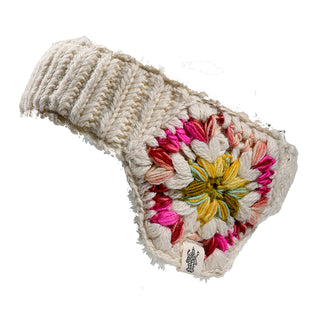 The Avon Headband is a cream-colored knitted ear warmer featuring a wide band and a decorative circular floral pattern in yellow, green, pink, and red on one side.