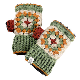 The Ryan Handwarmers are a pair of crocheted fingerless gloves with cream, green, mustard, orange, and red granny squares, ribbed green cuffs, and a red thumb; the gloves are shown overlapping each other.