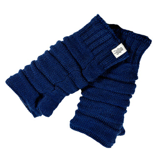 The Reverse Step Handwarmers are navy blue knit leg warmers with a ribbed texture and a small white tag on one cuff, folded and overlapping against a white background—perfect winter accessories.