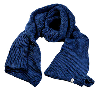 The Ithaca Scarf, a long, textured dark blue knit accessory with a small white tag on one end, is displayed against a white background.