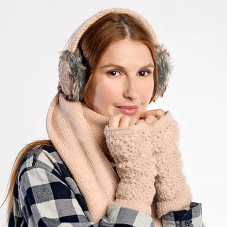 A woman wearing plaid, beige earmuffs, a matching knit scarf, and Flower Crochet Handwarmers poses with a neutral expression against a plain light background.