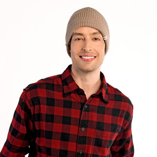 A man wearing the beige Bond Hat and a red and black plaid shirt stands against a plain white background, smiling at the camera.
