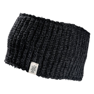 The Mandy Headband is a black, ribbed knit headband with a small rectangular logo tag on the front. Its soft texture offers warmth.