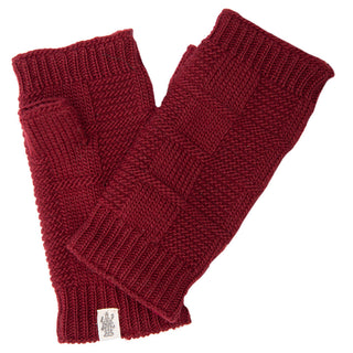 A pair of Checkered Handwarmers, dark red knit fingerless gloves handmade in Nepal, is laid flat on a white background. The gloves have a textured pattern and a small white label with a logo on one glove.