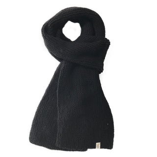 A handmade, black Roam Scarf on a white background.