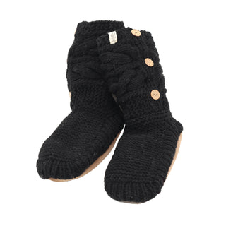 The Slipper Socks with 3 Buttons are a cozy pair of black knitted wool slippers adorned with a textured pattern and three tan buttons on the side. Made from 100% wool, they feature soles crafted from a soft, light brown material. These slipper socks are positioned side by side on a plain white background.