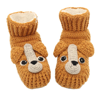 Introducing the Lucy Puppy Slippers: a pair of knitted, orange booties for a baby or toddler. These charming slippers feature an adorable puppy face design with large eyes, a nose, and ears. The tops of the slippers have a ribbed texture, ensuring a snug fit around tiny ankles.