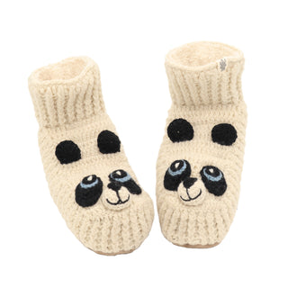 A pair of Panda Slippers made from beige, 100% wool, hand-knit in Nepal to feature playful faces. They have black ears, eyes, and a nose stitched onto the front for a cozy and warm feel.