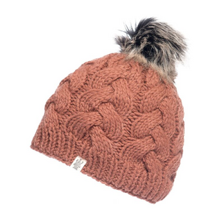 The Boheme Cable Beanie w/ Faux Fur Pom is a knitted, rust-colored hat featuring an elegant cable pattern and a faux fur pompom on top. Crafted from 100% Merino Wool, this winter beanie also includes a small white tag with an emblem near the brim.